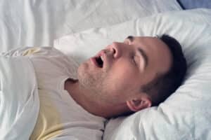 portrait man sleeping with open mouth problem snoring during sleep young cute guy sleeps white bed day morning Home Page
