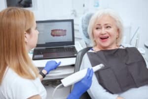 senior female patient having dental scanning by her dentist clinic Blog