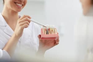 smiling dentist explaining tooth implantation Blog