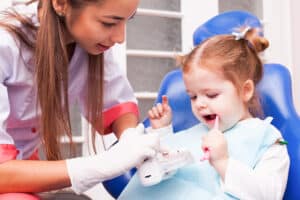 two years old girl is learning brush her teeth with toothbrush hand dental office Blog