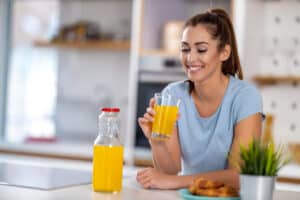 woman drinking glass fresh orange juice Blog